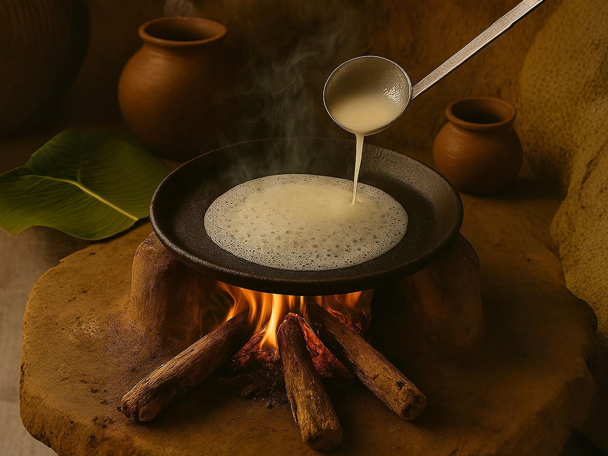 Pouring Neer Dose batter on a firewood tawa